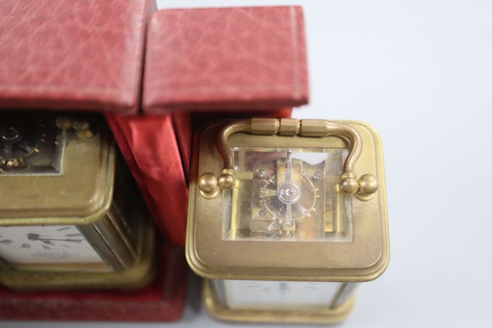 A cased lacquered brass miniature carriage timepiece and two others